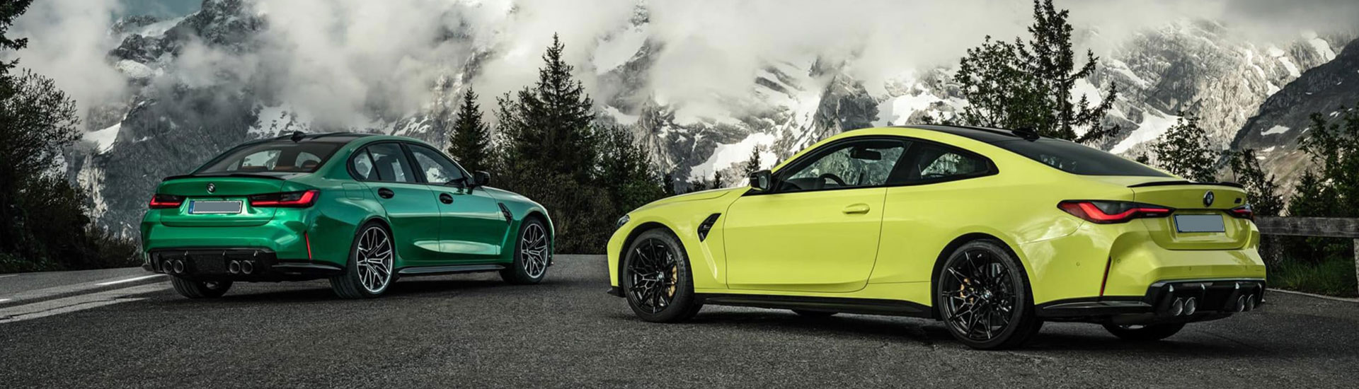 BMWs with mountains in the background